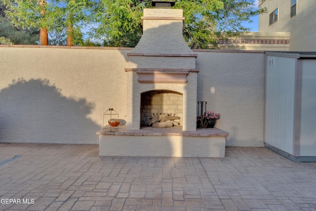 view of patio / terrace with exterior fireplace