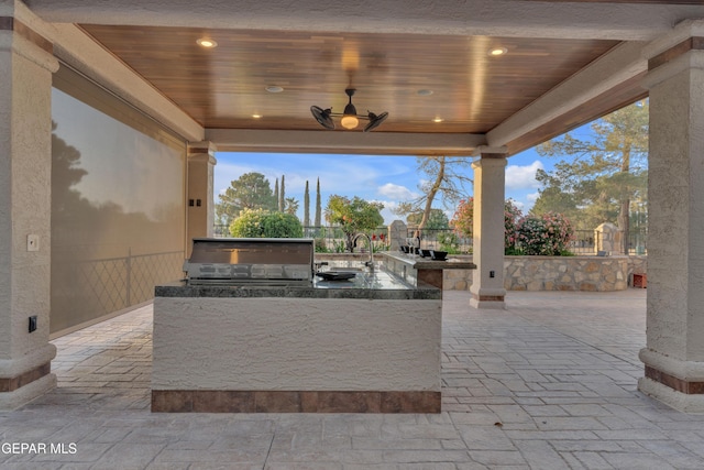 view of patio / terrace featuring area for grilling, a sink, and outdoor wet bar