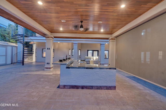 view of patio featuring outdoor wet bar, area for grilling, and stairway