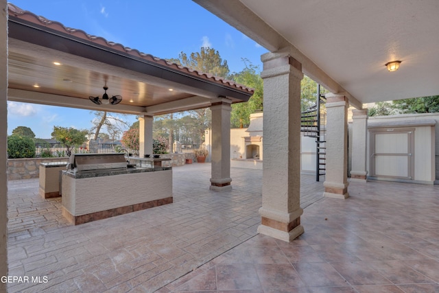 view of patio with an outdoor kitchen, fence, and grilling area