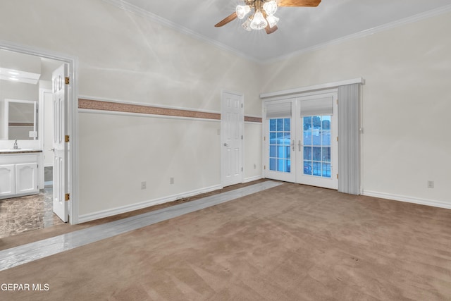 empty room featuring ceiling fan, french doors, crown molding, a sink, and baseboards