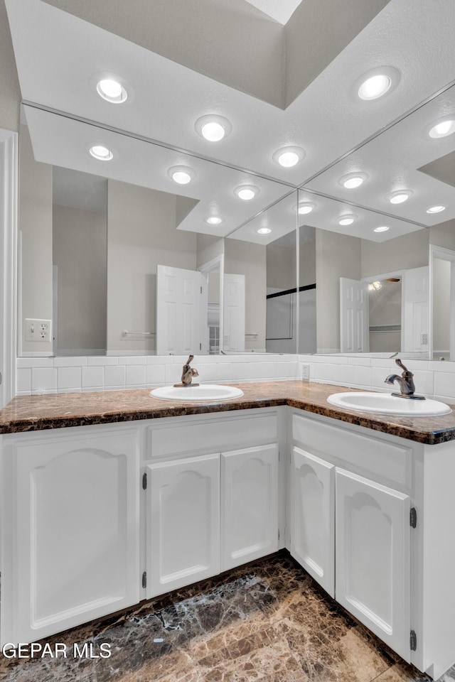 bathroom with double vanity and a sink
