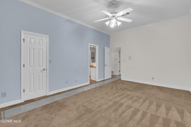 spare room featuring crown molding, a ceiling fan, carpet flooring, and baseboards