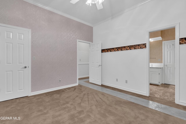 unfurnished bedroom with a ceiling fan, baseboards, ornamental molding, and carpet