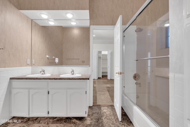 full bathroom with double vanity, tile patterned floors, a sink, and shower / bath combination with glass door