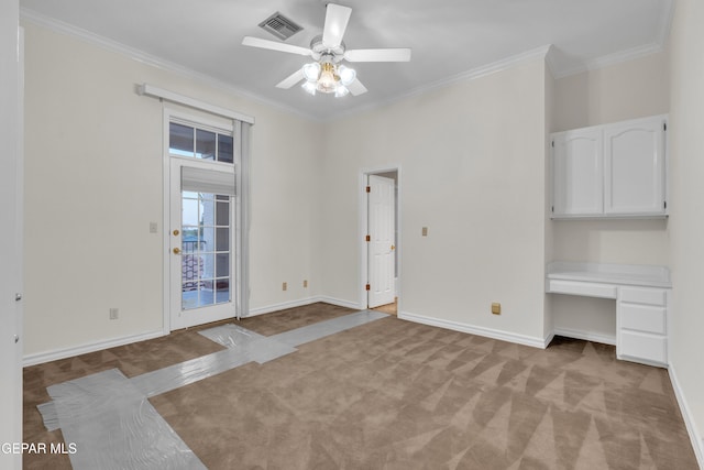 interior space with crown molding, light colored carpet, a ceiling fan, and visible vents