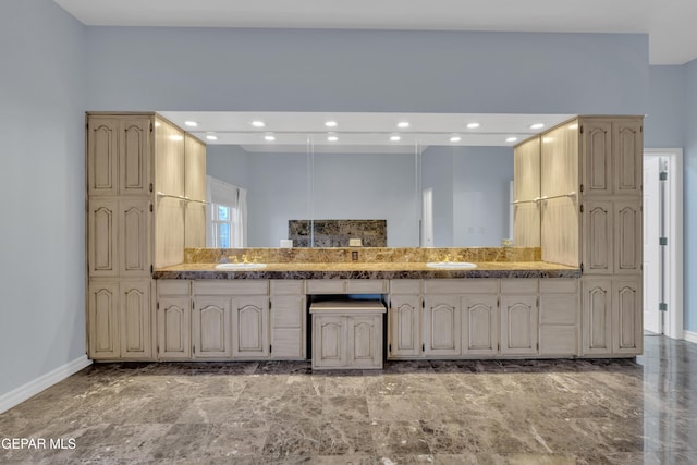kitchen featuring a sink, baseboards, and recessed lighting