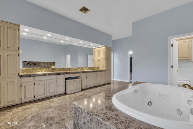 bathroom with visible vents, recessed lighting, a whirlpool tub, and vanity