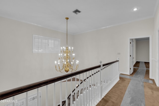 hallway featuring a chandelier, visible vents, an upstairs landing, ornamental molding, and light carpet