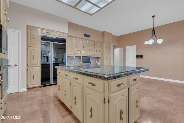 kitchen with cream cabinets, baseboards, high quality fridge, and tasteful backsplash