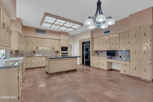 kitchen featuring a sink, decorative backsplash, built in microwave, and visible vents