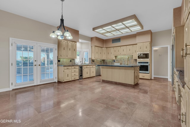 kitchen with cream cabinets, stainless steel appliances, decorative backsplash, and wine cooler