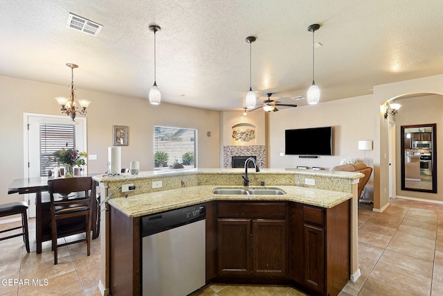 kitchen with stainless steel appliances, arched walkways, a sink, open floor plan, and visible vents