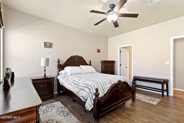 bedroom with visible vents, baseboards, dark wood-type flooring, and ceiling fan