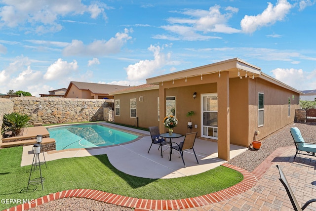 view of pool featuring a yard, a patio area, a fenced in pool, and a fenced backyard