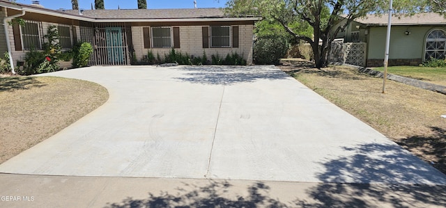 2704 Gaston Dr, El Paso, TX 79935 - ranch-style house with concrete driveway and fence