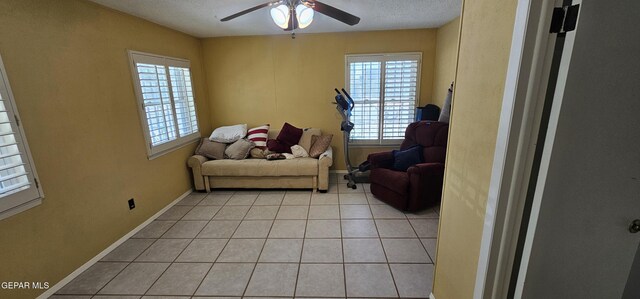 2704 Gaston Dr, El Paso, TX 79935 - living area featuring light tile patterned flooring, a ceiling fan, baseboards, and plenty of natural light