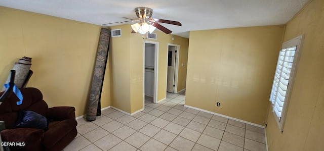 2704 Gaston Dr, El Paso, TX 79935 - living area with baseboards, visible vents, light tile patterned floors, and ceiling fan