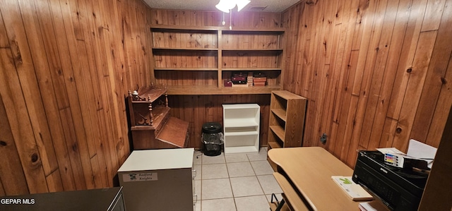 2704 Gaston Dr, El Paso, TX 79935 - home office with tile patterned floors, wooden walls, and a textured ceiling
