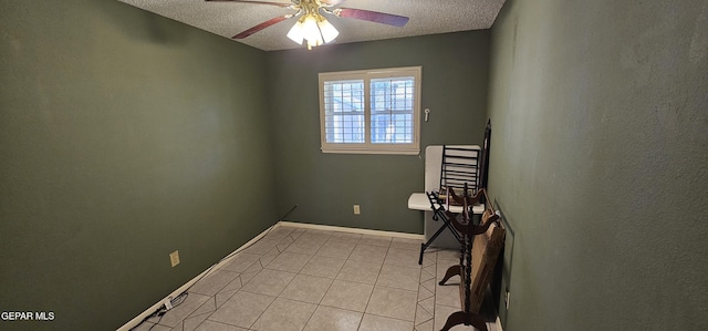 2704 Gaston Dr, El Paso, TX 79935 - unfurnished room featuring a textured ceiling, ceiling fan, light tile patterned floors, and baseboards