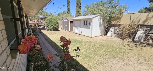 2704 Gaston Dr, El Paso, TX 79935 - view of yard with an outdoor structure, a shed, and a fenced backyard