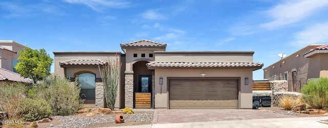7229 Camino Del Sol Dr, El Paso, TX 79911 - mediterranean / spanish-style house featuring stucco siding, driveway, an attached garage, and a tiled roof