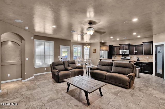 7229 Camino Del Sol Dr, El Paso, TX 79911 - living room featuring arched walkways, ceiling fan, baseboards, and recessed lighting