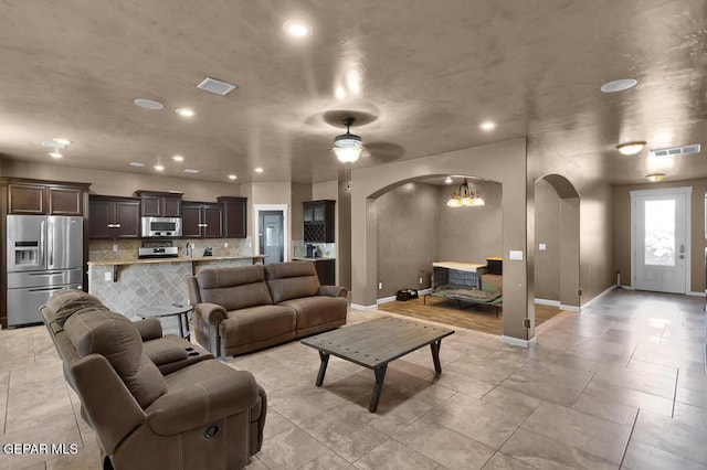 7229 Camino Del Sol Dr, El Paso, TX 79911 - living area with arched walkways, baseboards, recessed lighting, a chandelier, and a ceiling fan