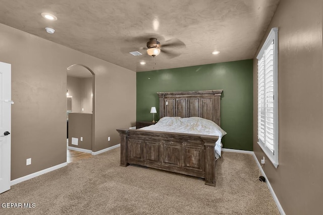 7229 Camino Del Sol Dr, El Paso, TX 79911 - bedroom featuring arched walkways, light carpet, baseboards, and recessed lighting