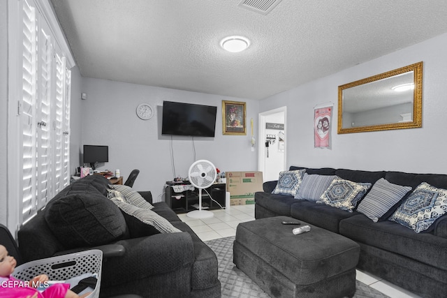 1808 Loanda Ln, El Paso, TX 79928 - living room featuring tile patterned flooring, visible vents, and a textured ceiling