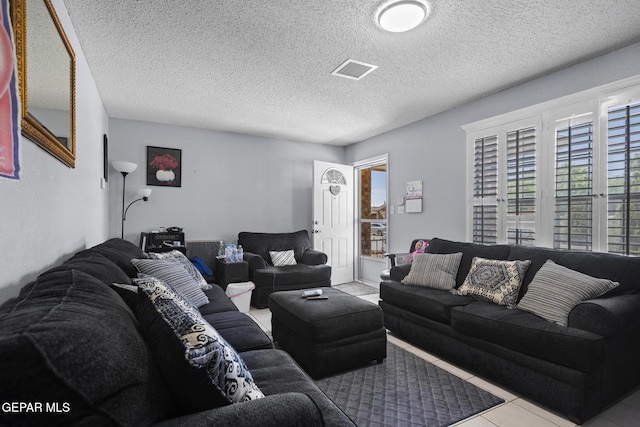 1808 Loanda Ln, El Paso, TX 79928 - tiled living room featuring visible vents and a textured ceiling