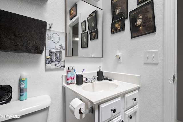 1808 Loanda Ln, El Paso, TX 79928 - bathroom with a textured wall, vanity, and toilet