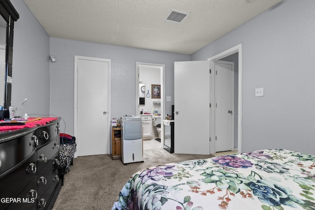 1808 Loanda Ln, El Paso, TX 79928 - bedroom with a textured ceiling, visible vents, light carpet, and ensuite bathroom