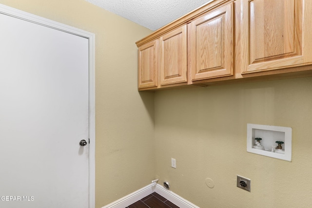 laundry room with gas dryer hookup, washer hookup, electric dryer hookup, cabinet space, and baseboards