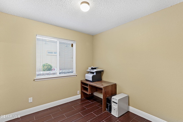 office space with baseboards, wood tiled floor, and a textured ceiling