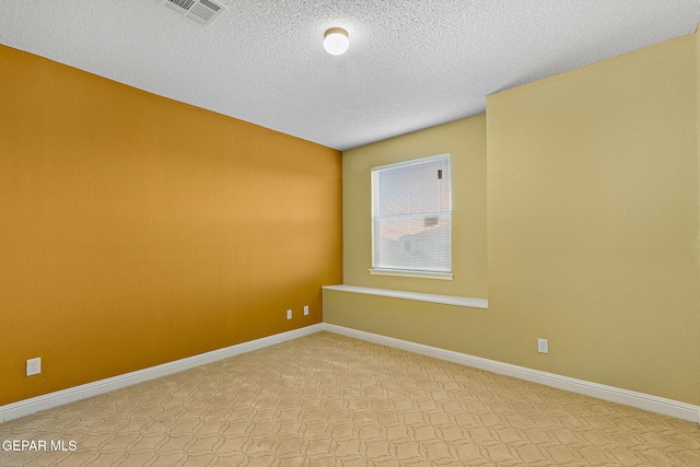 unfurnished room featuring visible vents, a textured ceiling, baseboards, and light colored carpet