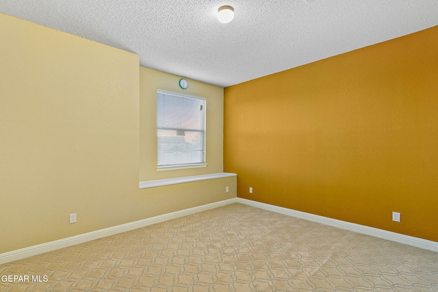 empty room featuring a textured ceiling