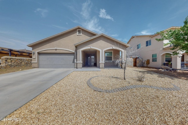 view of front of house with stucco siding, an attached garage, driveway, and a porch