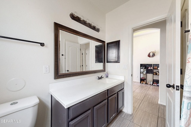 bathroom featuring tile patterned floors, vanity, and toilet