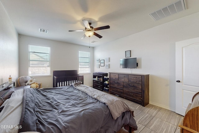 bedroom with visible vents, a ceiling fan, and baseboards