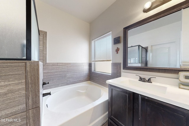 full bath with a garden tub and vanity