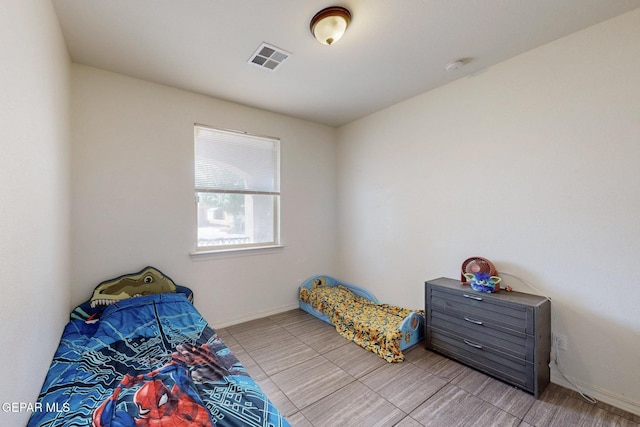 bedroom with baseboards and visible vents
