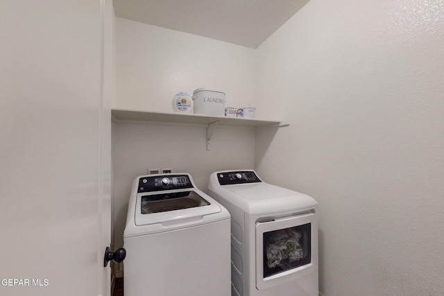 washroom featuring laundry area and washer and clothes dryer