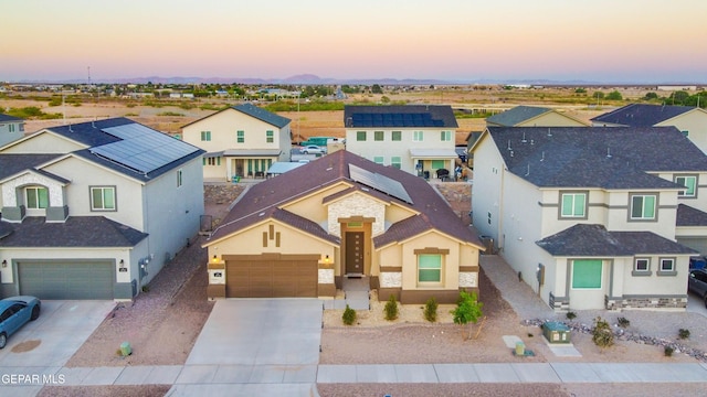 10716 Drew Pearson Dr, El Paso, TX 79924 - view of front of property featuring concrete driveway, a residential view, and stucco siding