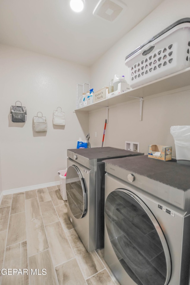 10716 Drew Pearson Dr, El Paso, TX 79924 - clothes washing area featuring washer and dryer, baseboards, and laundry area