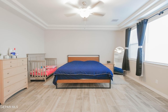 10716 Drew Pearson Dr, El Paso, TX 79924 - bedroom featuring a tray ceiling, light wood-style floors, baseboards, and ceiling fan
