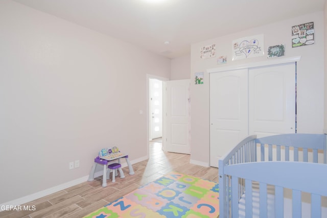 10716 Drew Pearson Dr, El Paso, TX 79924 - bedroom featuring wood tiled floor, a closet, and baseboards