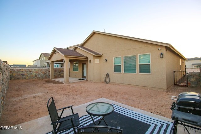10716 Drew Pearson Dr, El Paso, TX 79924 - rear view of property featuring stucco siding, a fenced backyard, a gate, and a patio