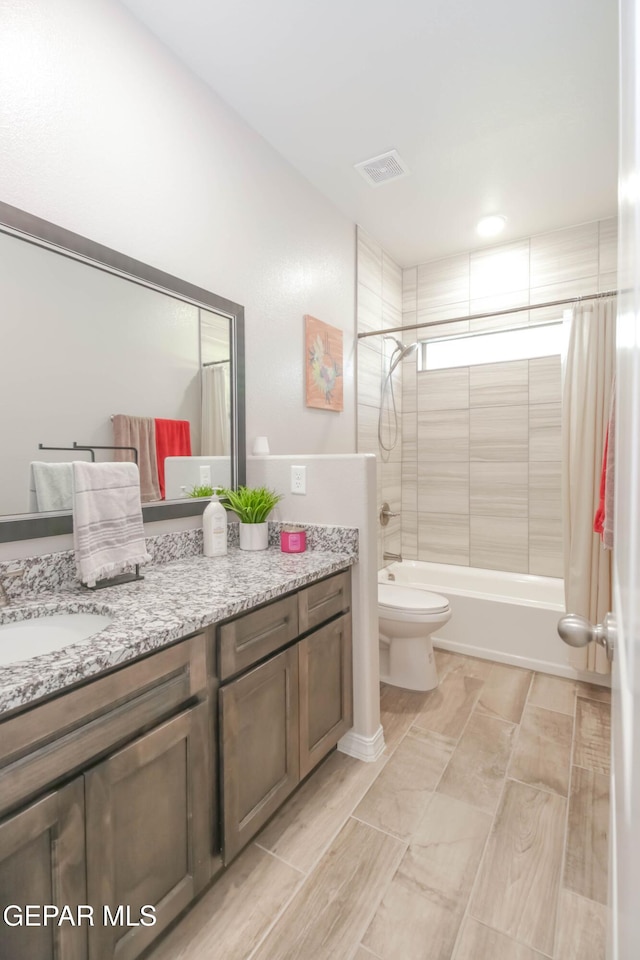 10716 Drew Pearson Dr, El Paso, TX 79924 - full bathroom with shower / bath combo with shower curtain, visible vents, vanity, and toilet