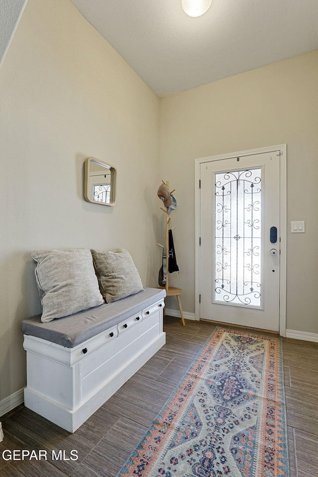 entrance foyer with baseboards and wood finished floors